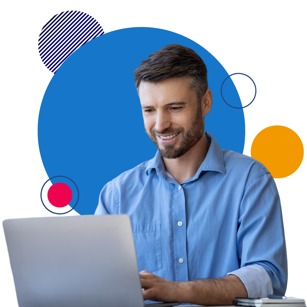 Man in blue button down on laptop smiling